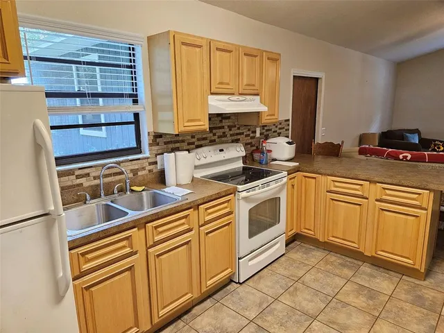 a kitchen with stainless steel appliances granite countertop a sink and cabinets