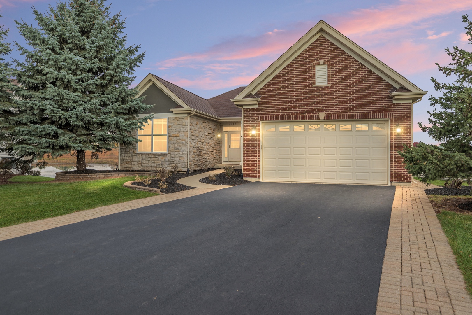 a front view of a house with a yard and garage