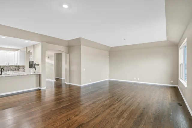 a view of a room with wooden floor