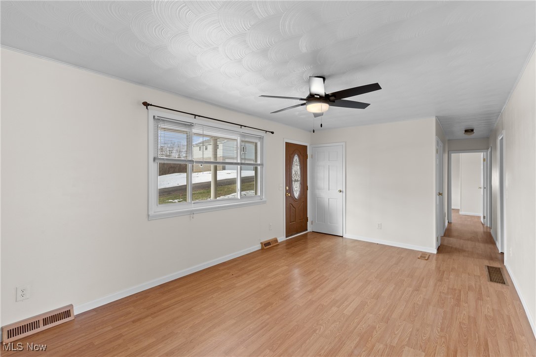 61899 Webb Heights Road Shadyside, OH 43947 - Photo 6 of 39 Empty room featuring light hardwood / wood-style floors and ceiling fan