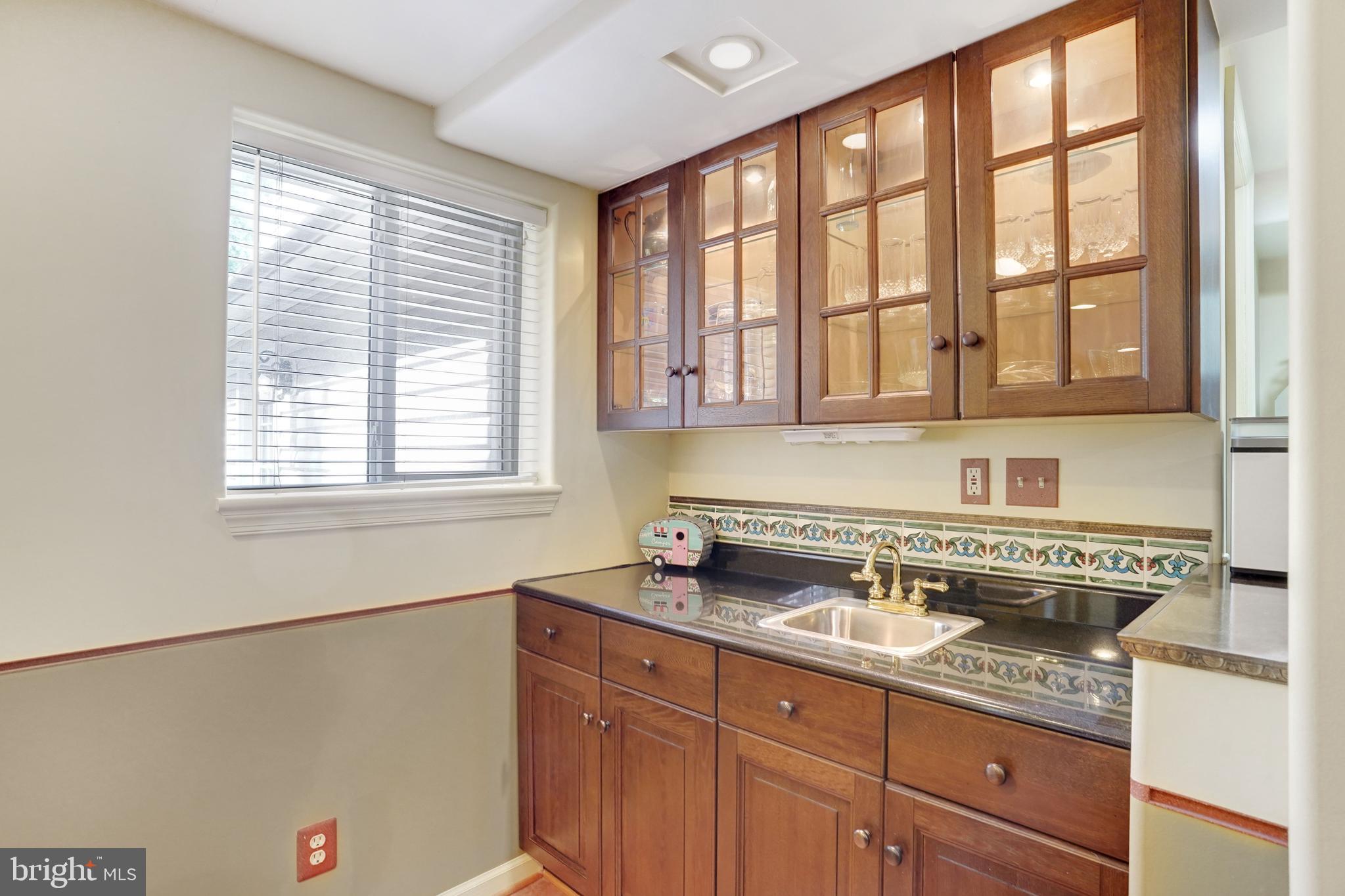 5300 Kings Park Drive Springfield, VA 22151 - Photo 44 of 62 a kitchen with stainless steel appliances granite countertop a sink stove and cabinets