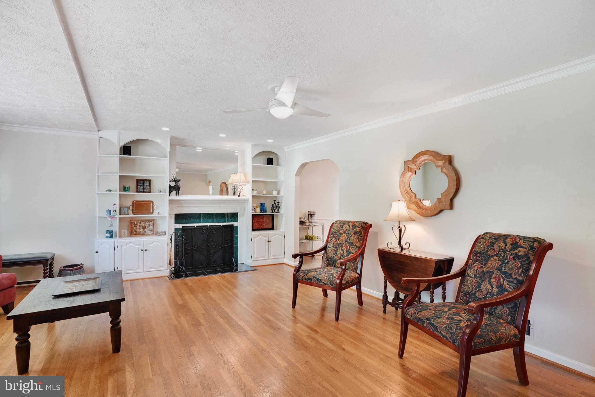 5300 Kings Park Drive Springfield, VA 22151 - Photo 9 of 62 a view of a livingroom with furniture a fireplace a chandelier and wooden floor