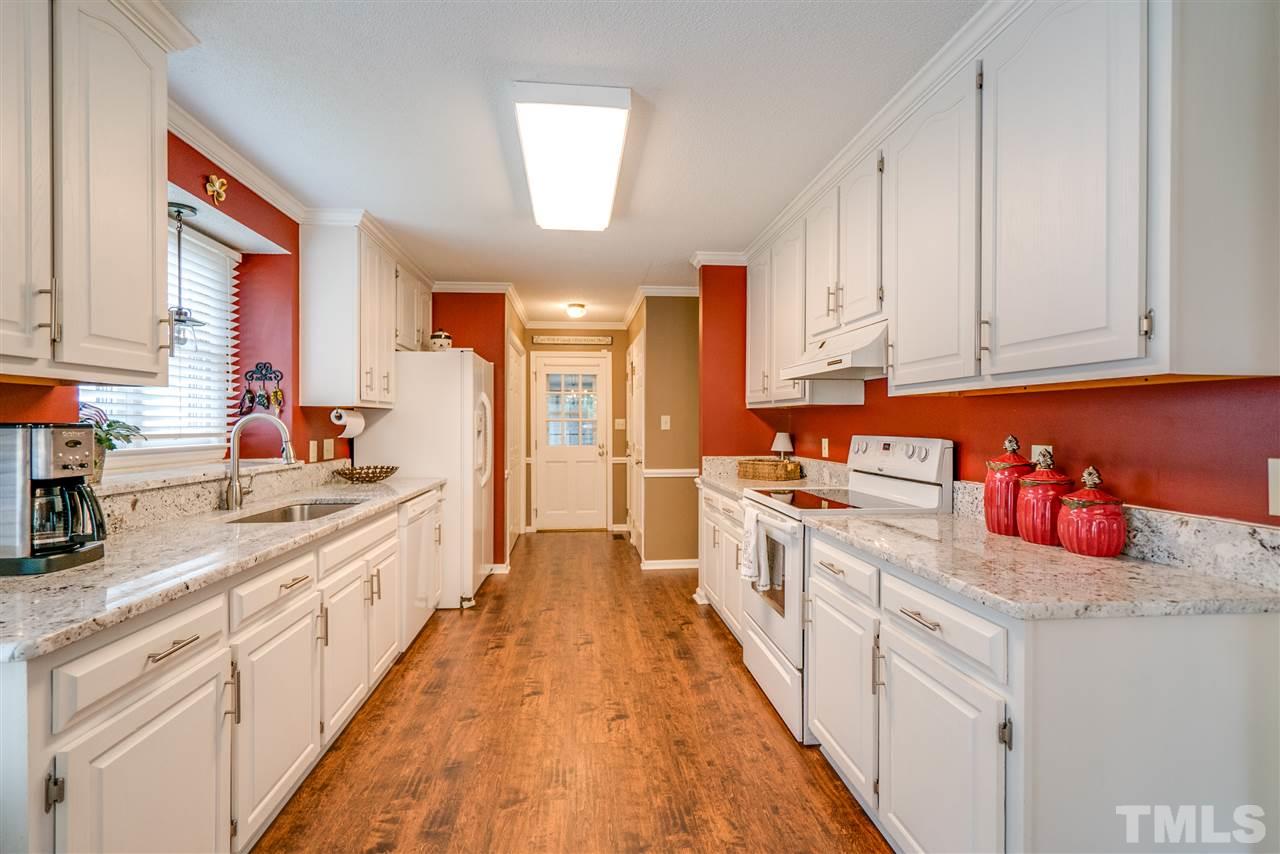 4541 Birmingham Way Raleigh, NC 27604 - Photo 5 of 25 a kitchen with kitchen island granite countertop lots of counter top space and a sink