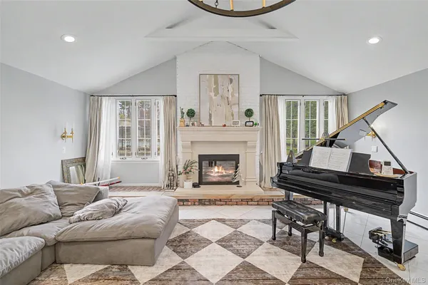 a living room with furniture and a fireplace