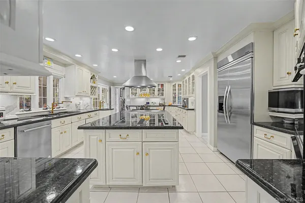 a kitchen with granite countertop kitchen island and stainless steel appliances