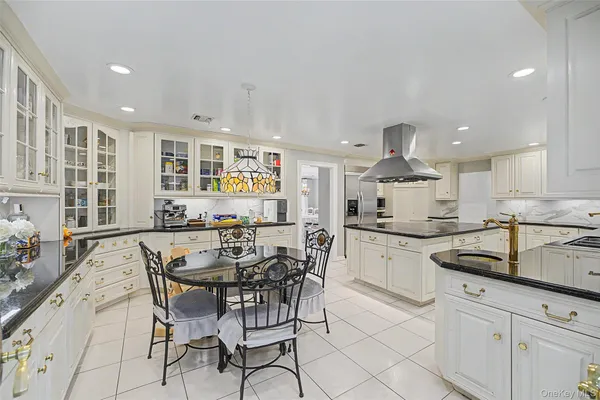 a kitchen with granite countertop stainless steel appliances a sink and cabinets