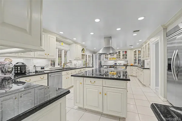 a kitchen with stainless steel appliances granite countertop a sink and cabinets
