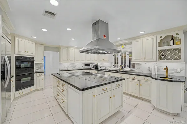 a kitchen with stainless steel appliances granite countertop a sink stove oven and refrigerator