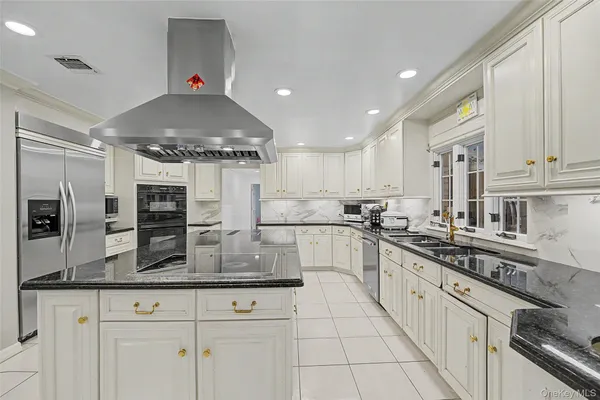 a kitchen with stainless steel appliances a sink stove and cabinets