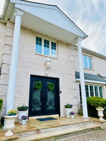 a front view of a house with garden