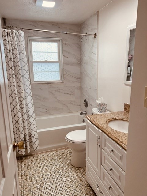 438 Old Bedford Road Concord, MA 01742 - Photo 19 of 31 a bathroom with a granite countertop toilet a sink and a bathtub