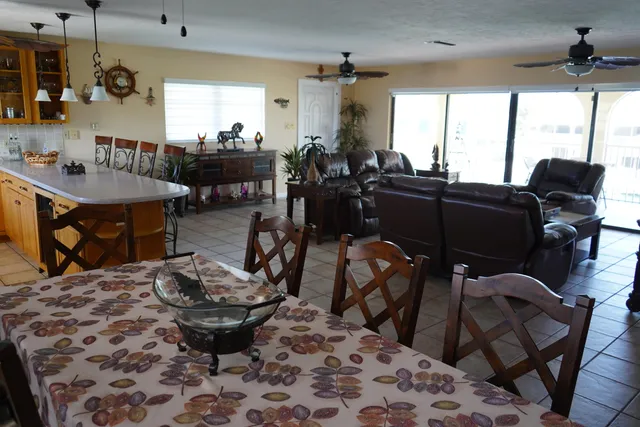 a living room with furniture a rug and a large window