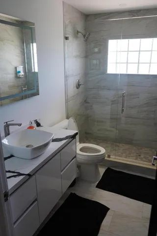 a bathroom with a sink toilet and shower