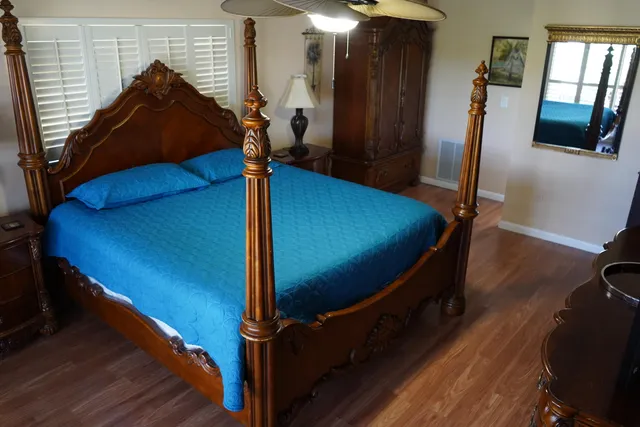 a bed sitting in a room next to a window