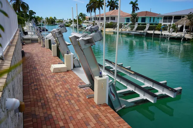a front view of a house with a garden and lake view