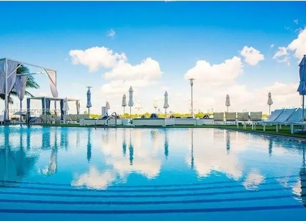 a view of a swimming pool with outdoor seating