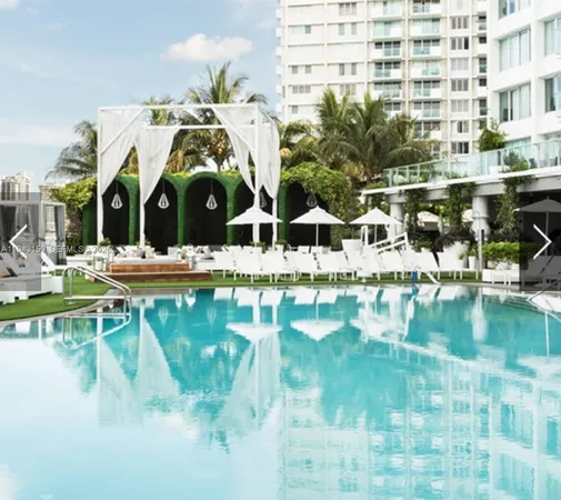 a view of a swimming pool with couches chairs and a table