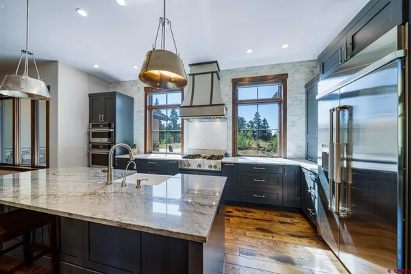 a kitchen with sink and refrigerator