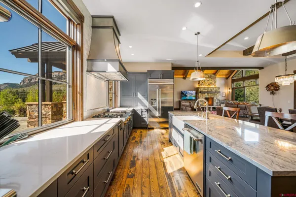 a large kitchen with stainless steel appliances granite countertop a lot of counter space