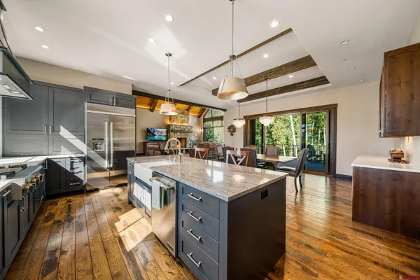 a kitchen with sink stove and view living room