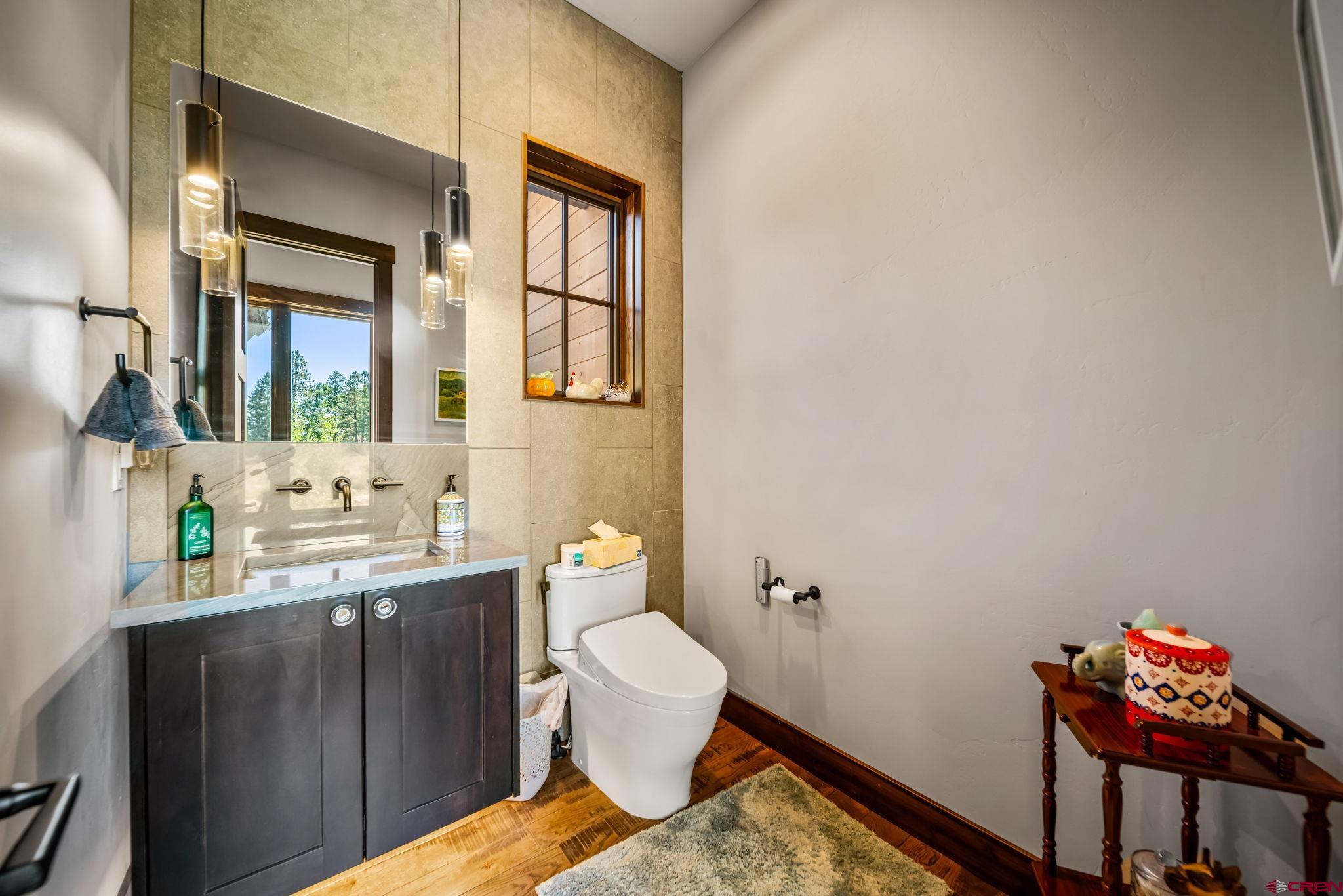 212 2 Dogs Trail Durango, CO 81301 - Photo 23 of 45 a bathroom with a sink mirror and toilet