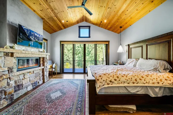 a bed sitting in a spacious bedroom next to a window