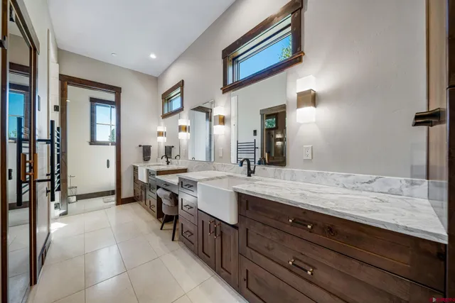a spacious bathroom with a granite countertop sink and a mirror