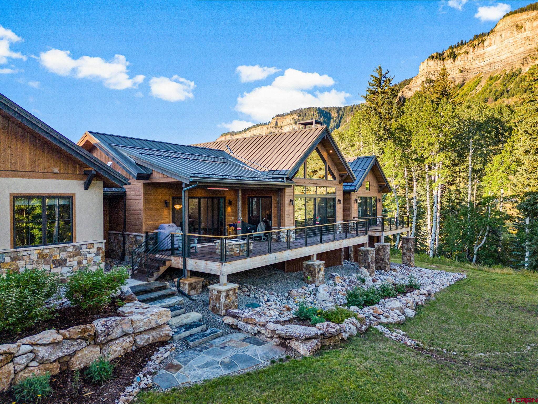 212 2 Dogs Trail Durango, CO 81301 - Photo 3 of 45 a front view of a house with garden