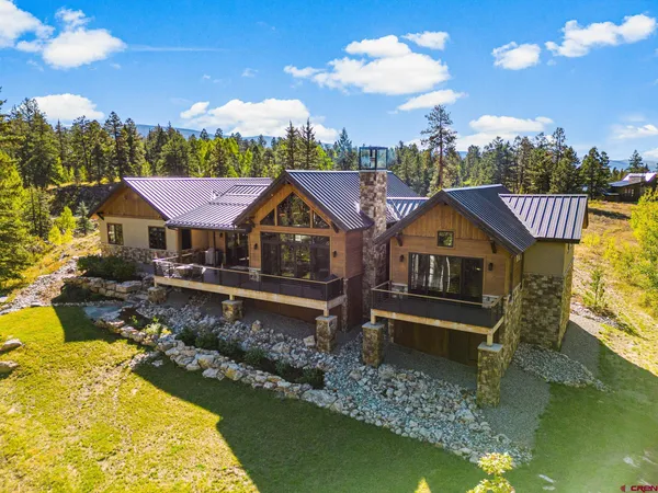 a front view of a house with a yard swimming pool and outdoor seating