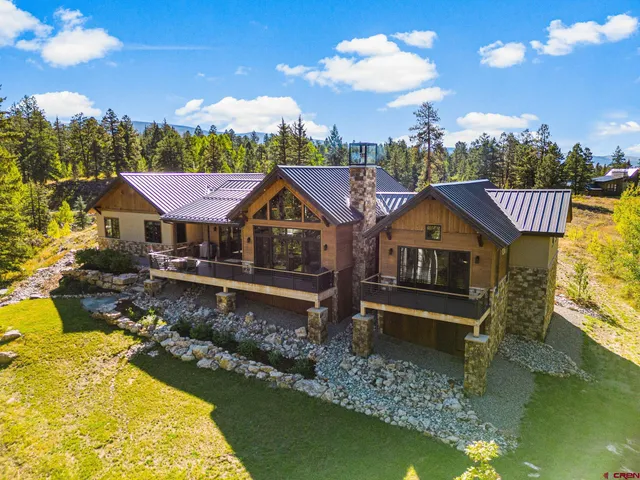 a front view of a house with a yard swimming pool and outdoor seating