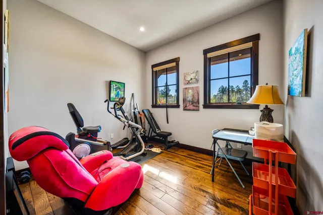a view of a workspace with furniture and gym equipment