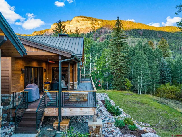 a view of a house with backyard outdoor seating and entertaining space