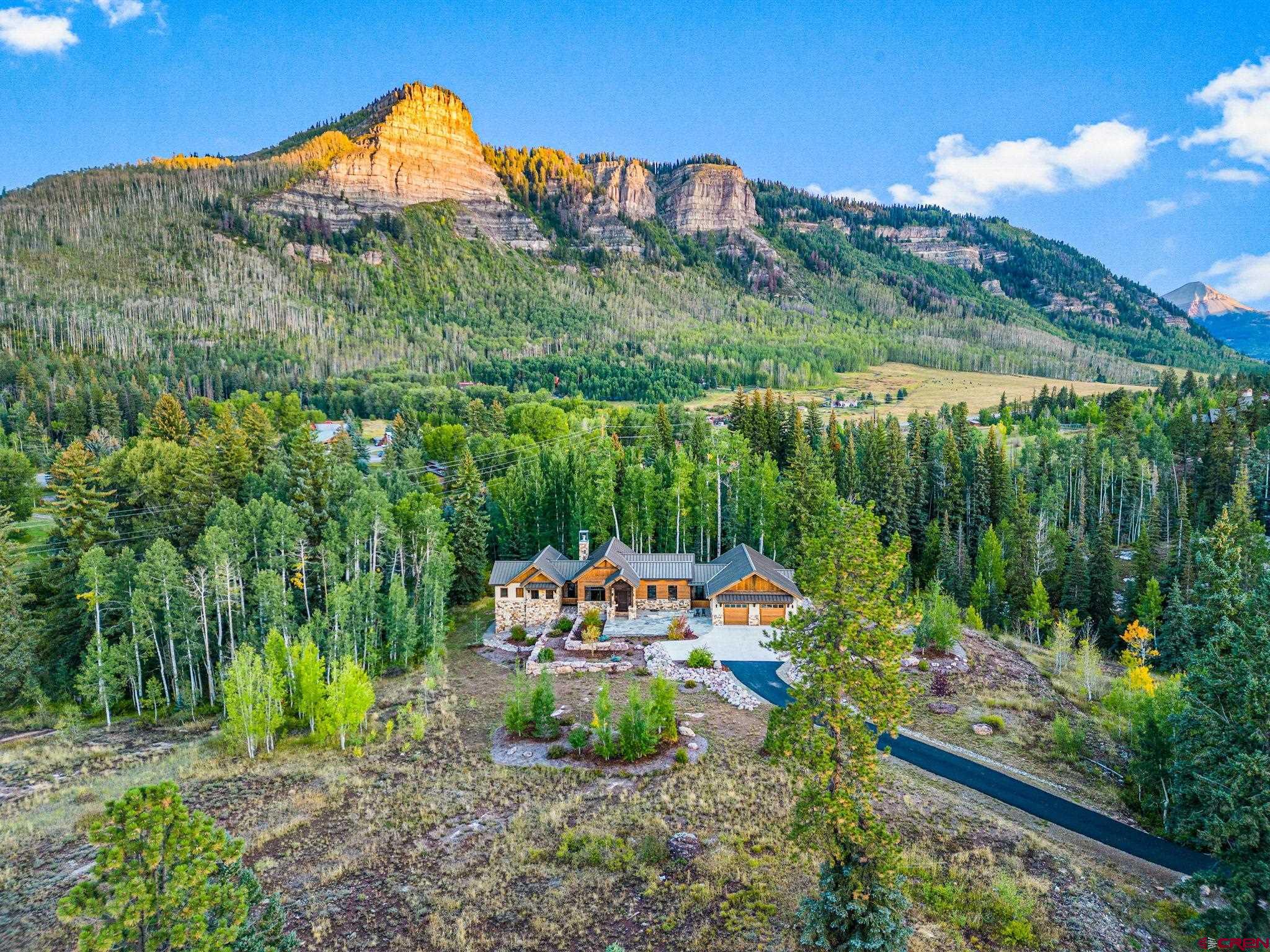 212 2 Dogs Trail Durango, CO 81301 - Photo 42 of 45 a backyard of a house with a yard and outdoor seating