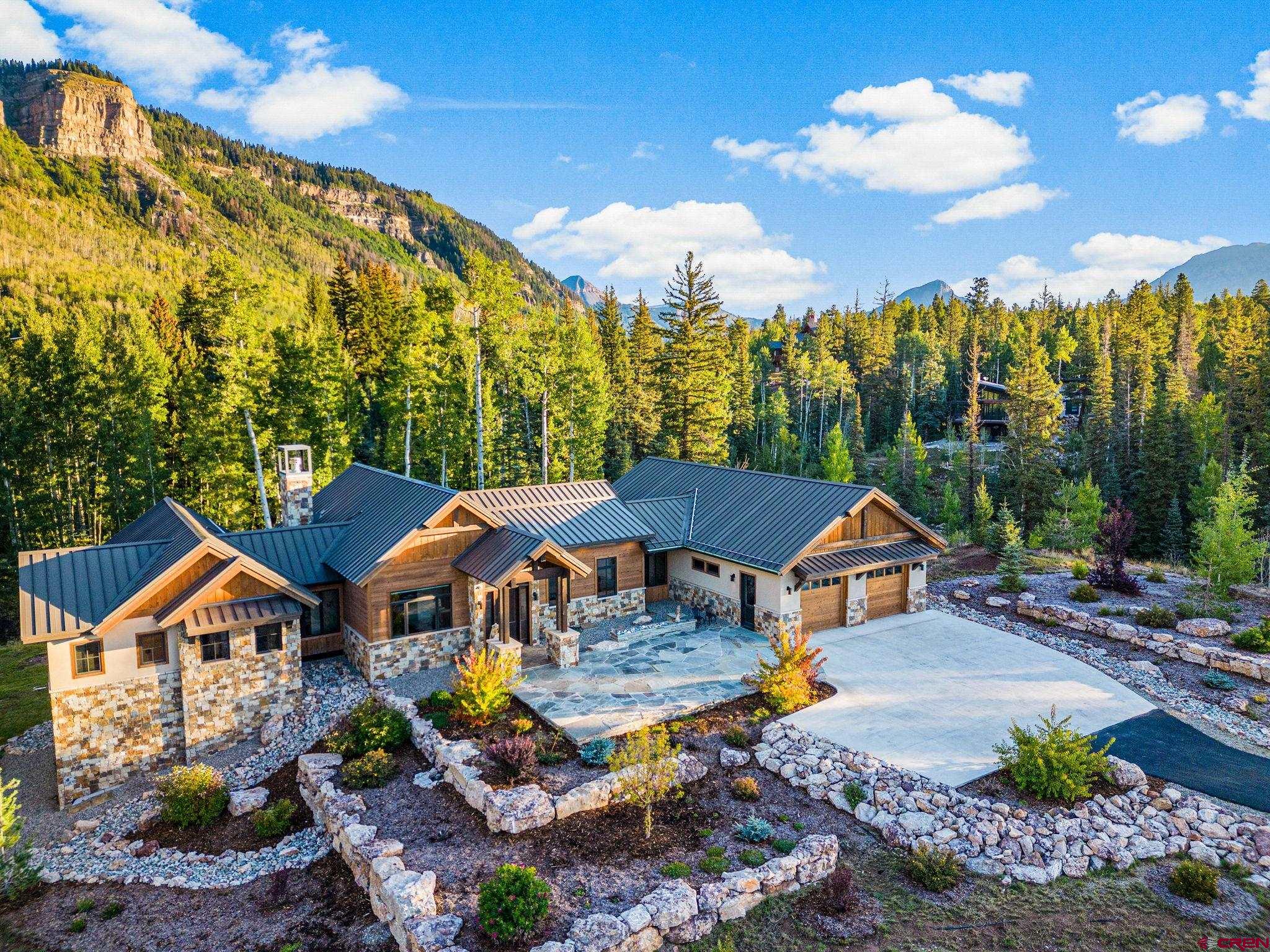 212 2 Dogs Trail Durango, CO 81301 - Photo 5 of 45 a front view of a house with a yard and outdoor seating