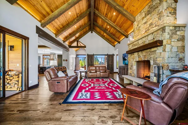 a living room with furniture a rug and a chandelier