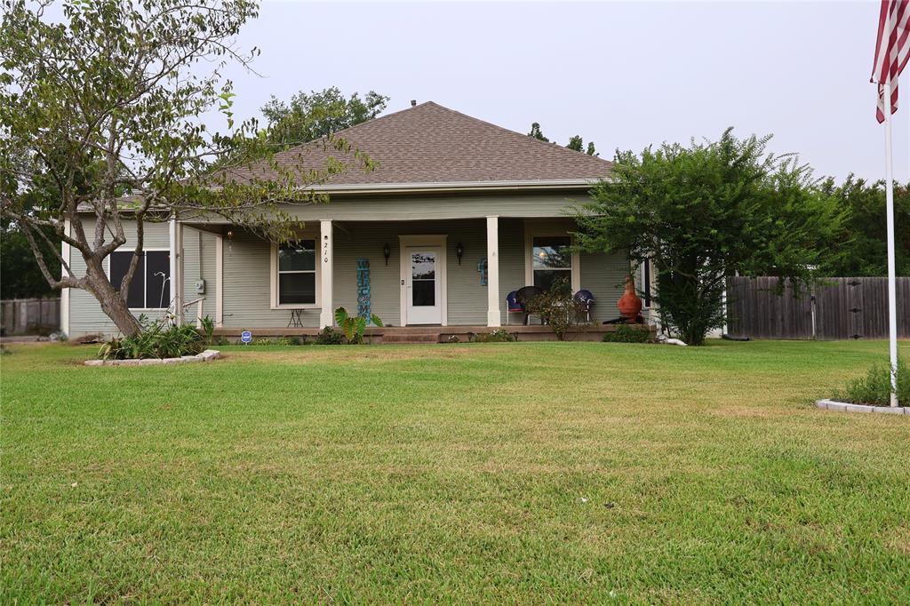 View of front of house featuring roof with shingles and a porch