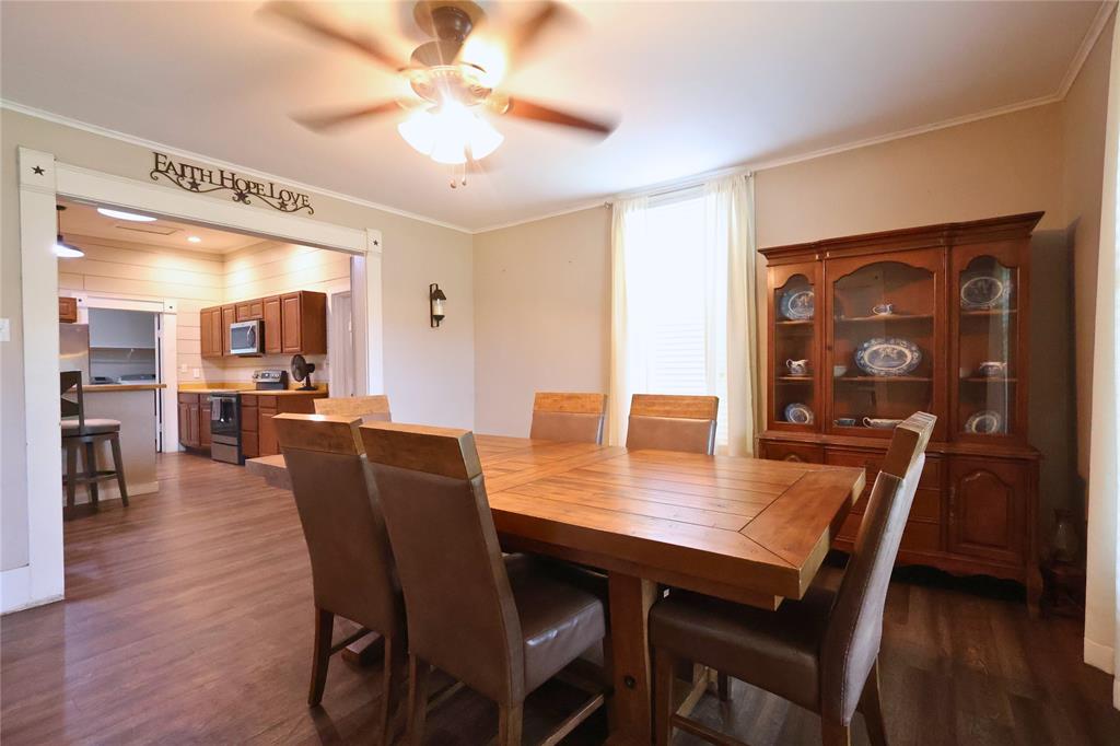 210 Hopkins Street Alba, TX 75410 - Photo 11 of 36 Dining room featuring ornamental molding, dark wood-style flooring, and a ceiling fan