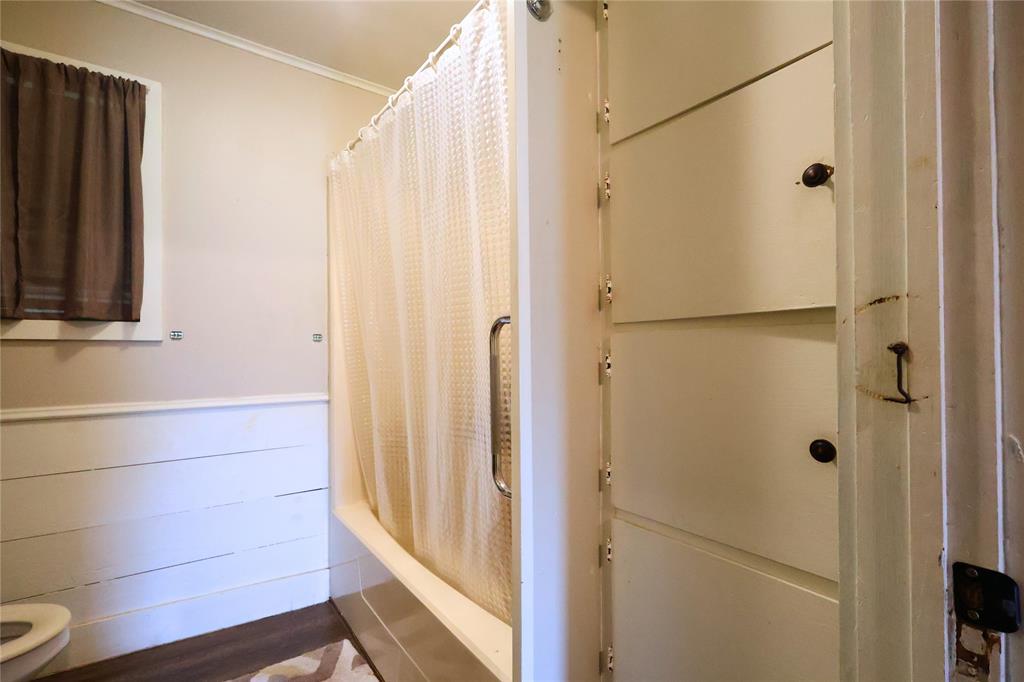 210 Hopkins Street Alba, TX 75410 - Photo 16 of 36 Bathroom with wainscoting, shower / tub combo, and crown molding