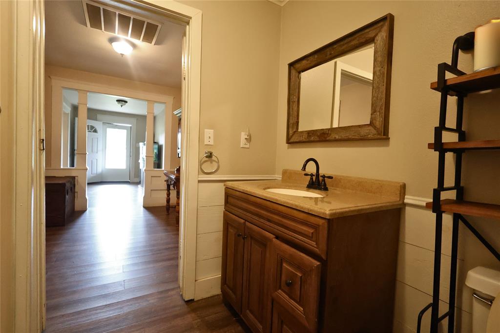 210 Hopkins Street Alba, TX 75410 - Photo 17 of 36 Bathroom with vanity and wood finished floors