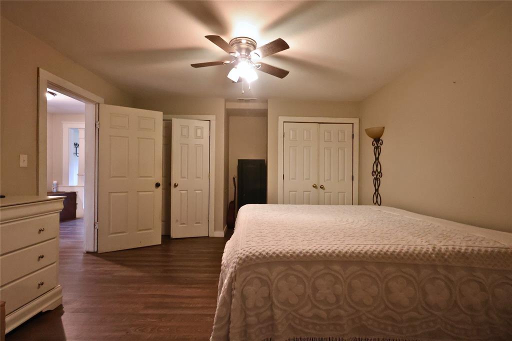 210 Hopkins Street Alba, TX 75410 - Photo 20 of 36 Bedroom with dark wood finished floors, two closets, and a ceiling fan