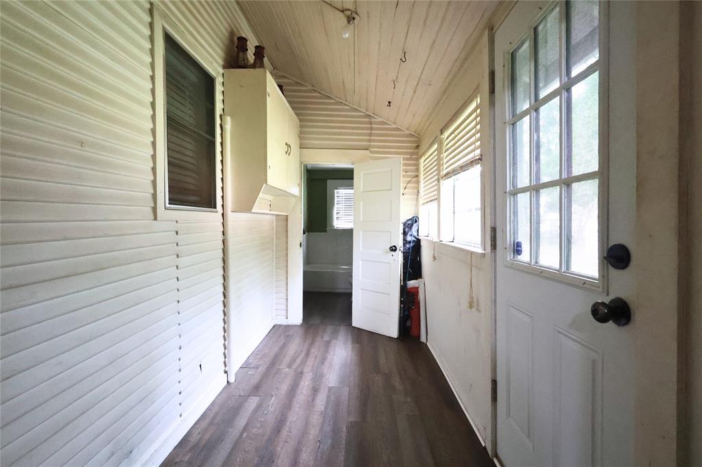 210 Hopkins Street Alba, TX 75410 - Photo 22 of 36 Doorway to outside featuring vaulted ceiling, dark wood finished floors, and wooden ceiling