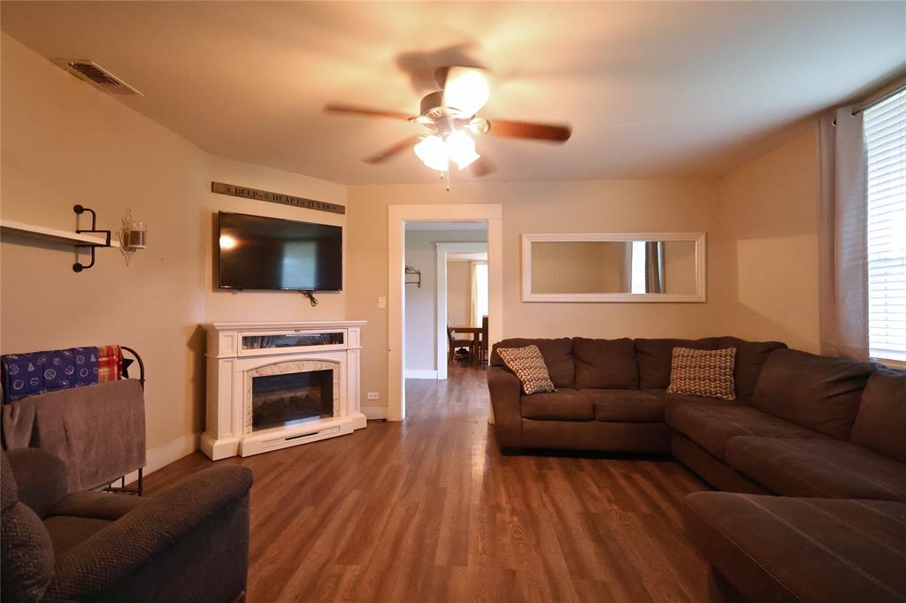 210 Hopkins Street Alba, TX 75410 - Photo 25 of 36 Living room with dark wood-type flooring, a fireplace, and ceiling fan