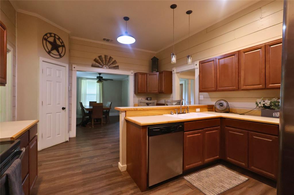210 Hopkins Street Alba, TX 75410 - Photo 7 of 36 Kitchen with dishwasher, dark wood-style floors, a peninsula, light countertops, and stove