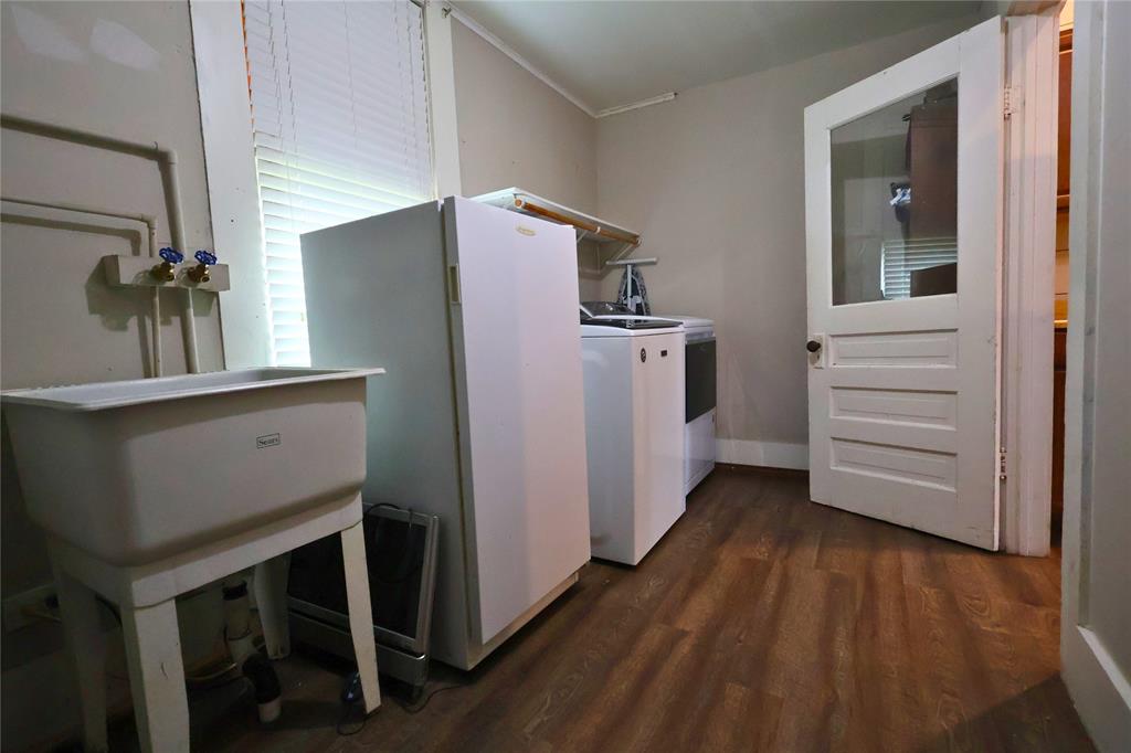 210 Hopkins Street Alba, TX 75410 - Photo 8 of 36 Laundry room featuring dark wood-type flooring and baseboards
