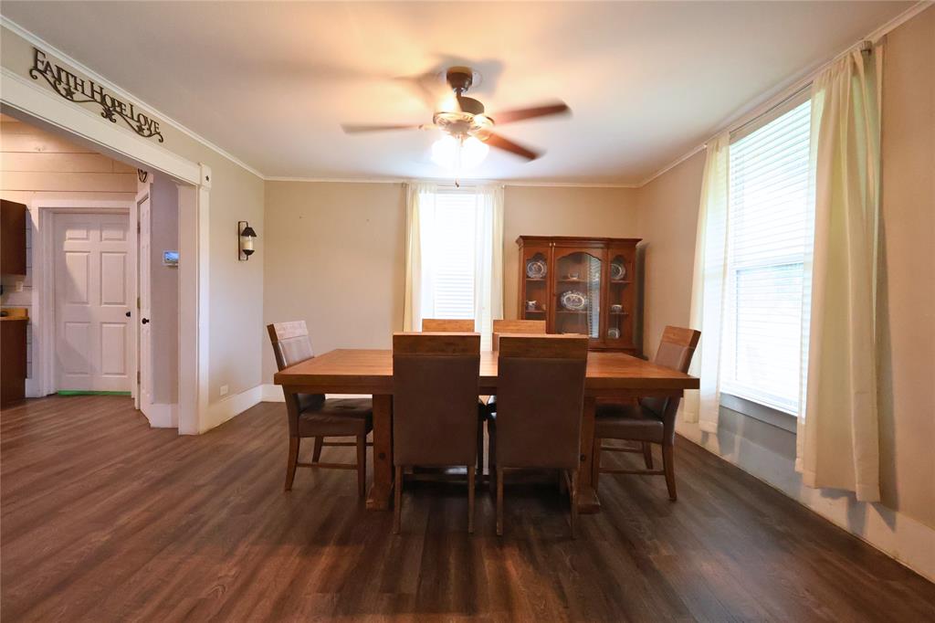 210 Hopkins Street Alba, TX 75410 - Photo 10 of 36 Dining space with ornamental molding, healthy amount of natural light, dark wood-style flooring, and a ceiling fan