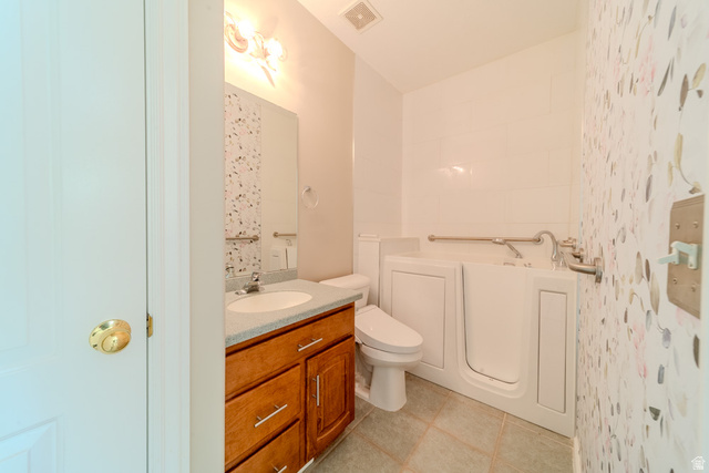 598 Hollow Creek Road Draper, UT 84020 - Photo 69 of 110 Bathroom featuring a walk-in tub with grab bars, a single vanity with a light-colored countertop, and a built-in mirror