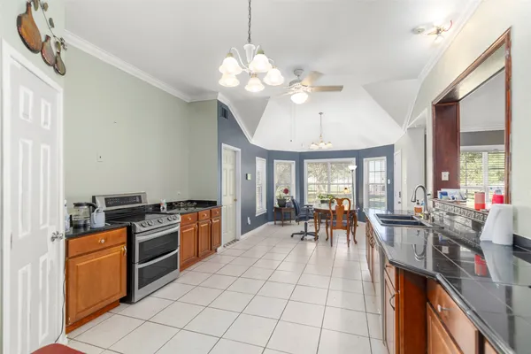 a kitchen with a stove and a chandelier
