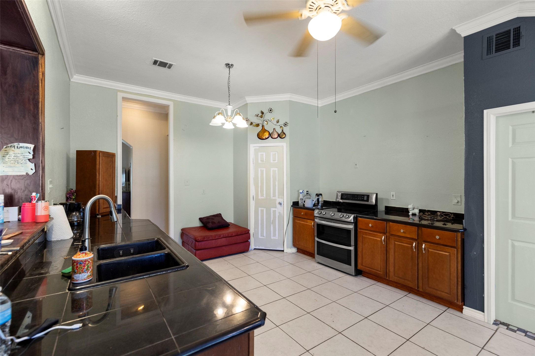 16004 Penick Road Waller, TX 77484 - Photo 18 of 50 a kitchen with a stove and a chandelier