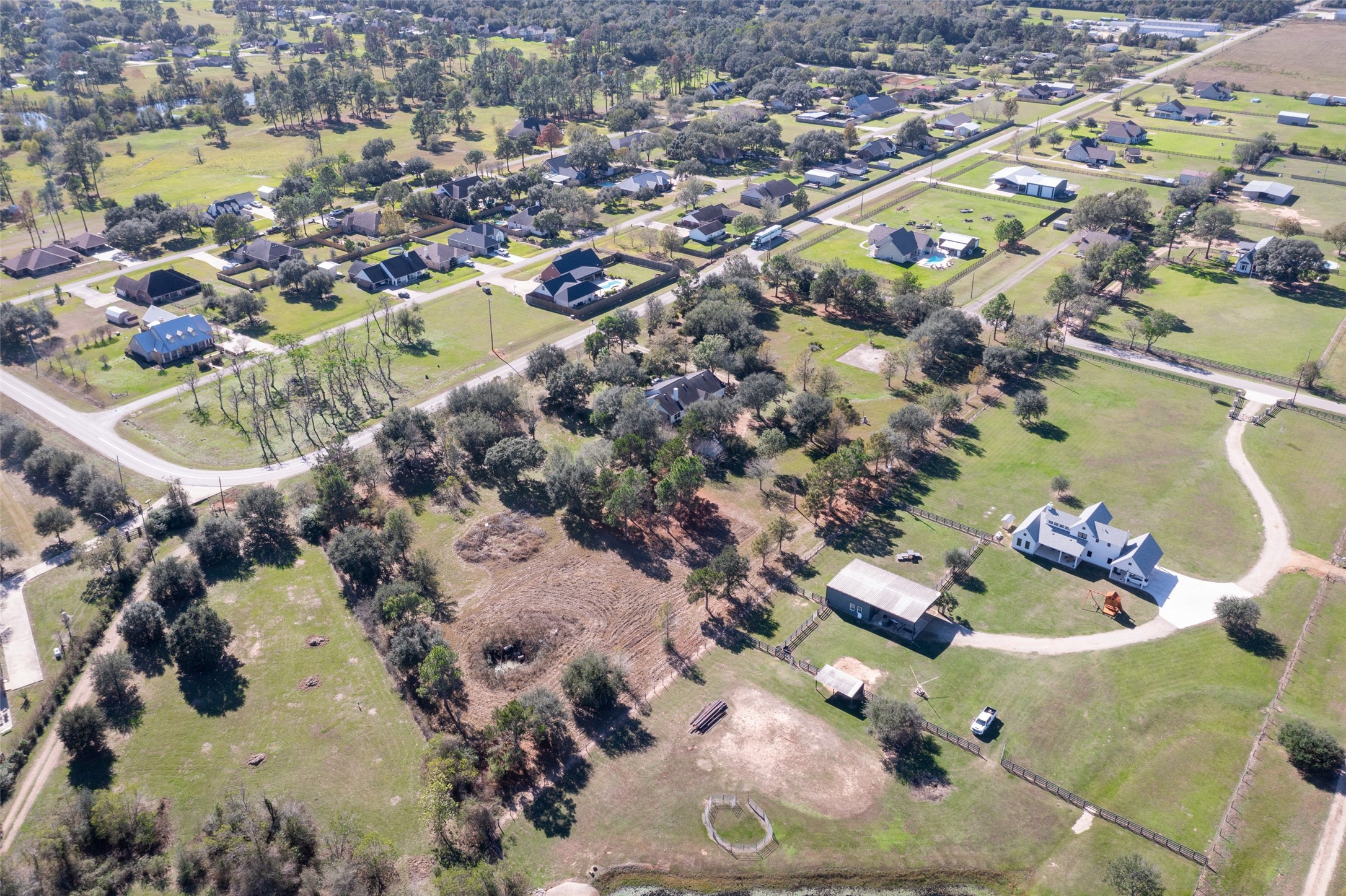 16004 Penick Road Waller, TX 77484 - Photo 50 of 50 an aerial view of a house with a swimming pool yard and lake view in back