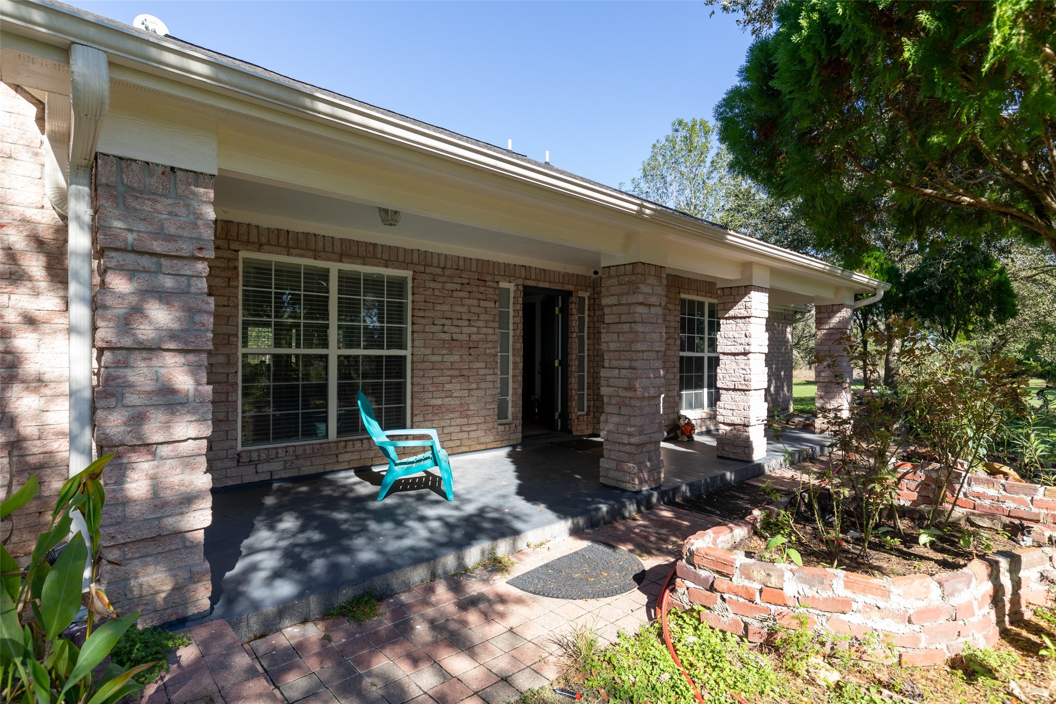 16004 Penick Road Waller, TX 77484 - Photo 7 of 50 a chair and table in front of a house